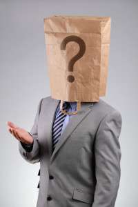 Anonymous businessman with paper bag on his head